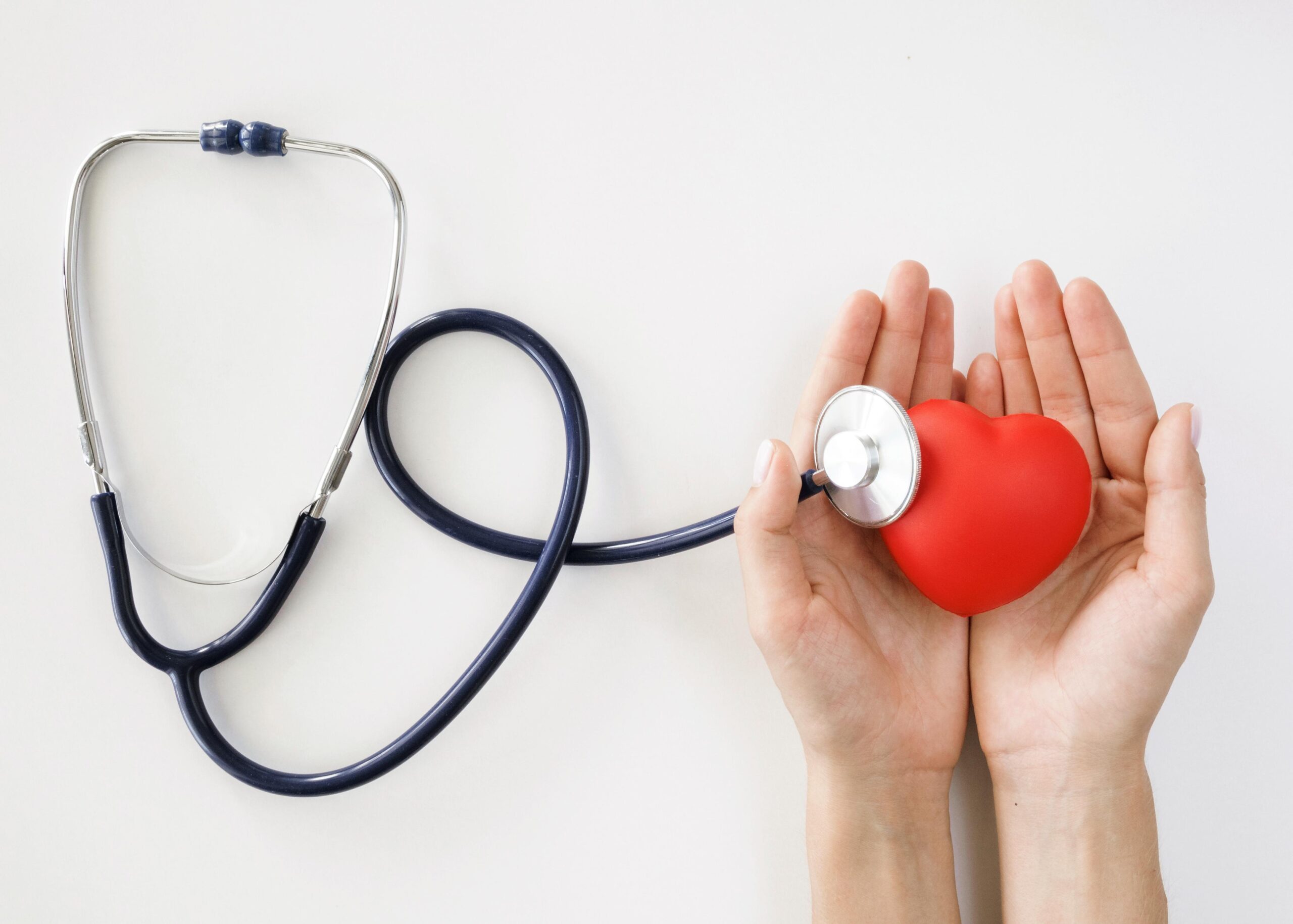 Hands holding a heart and a stethoscope