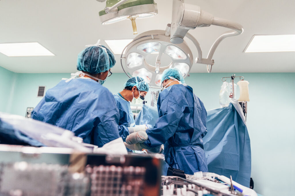 Team of 3 surgeons in an operating room