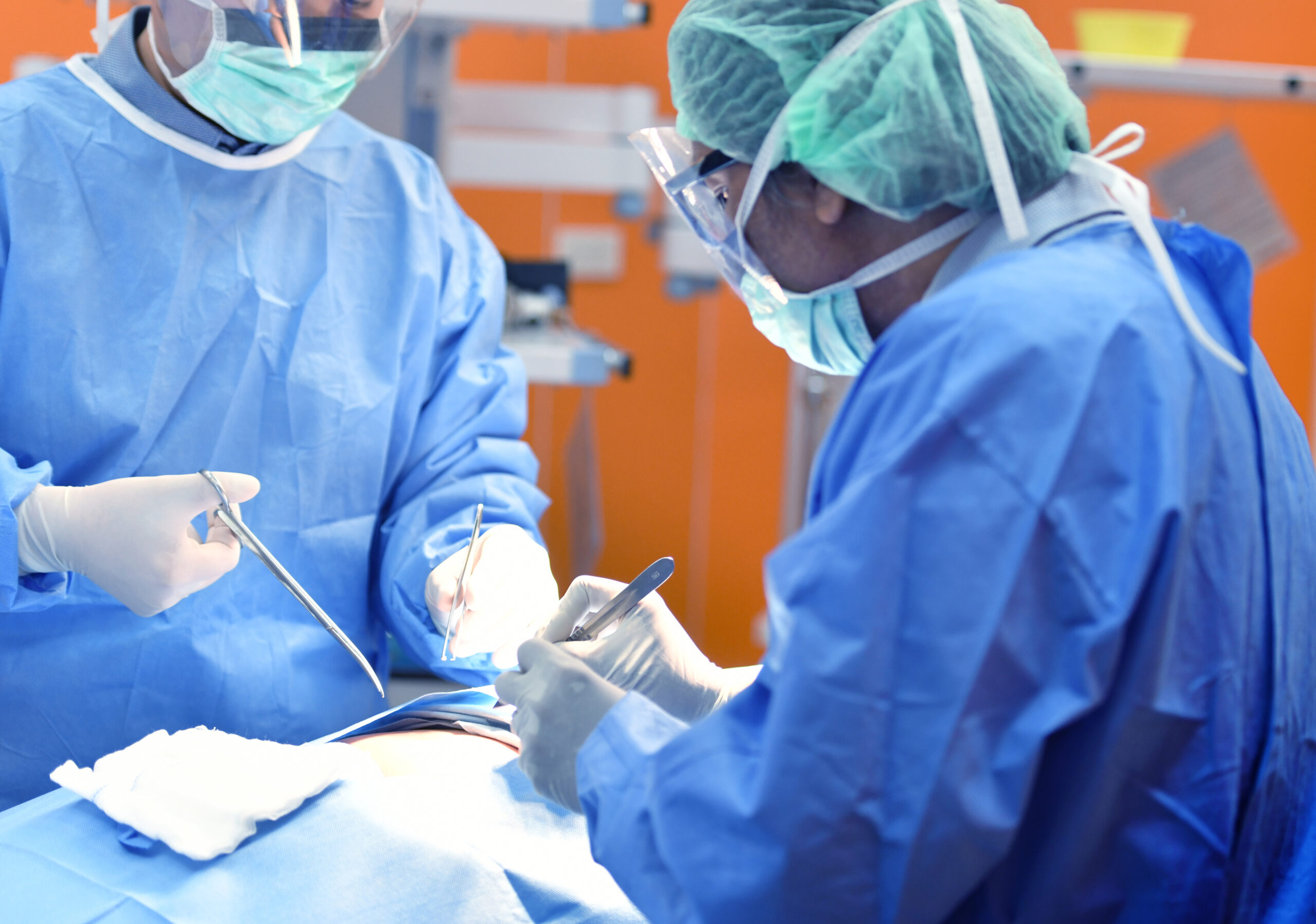 A team of surgeons during an operation working in a hospital ward.