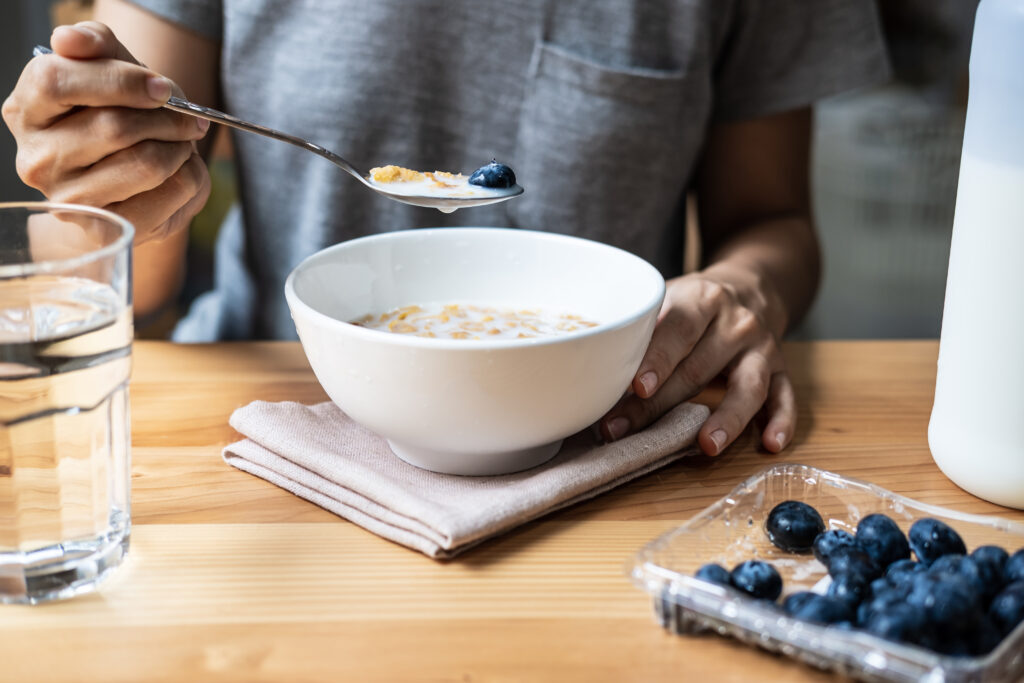 Woman eating healthy with a bowl of cereal